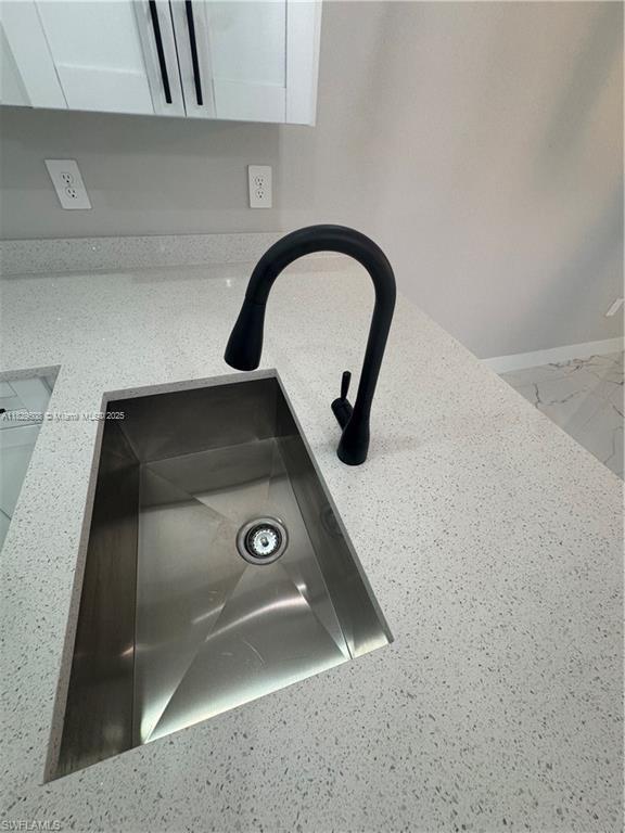 3003 18th St W, Lehigh Acres, FL 33976 - kitchen view of a sink and white cabinetry