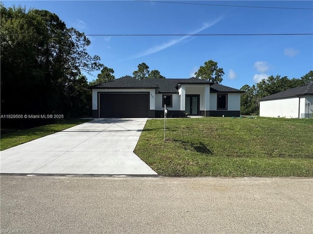 3003 18th St W, Lehigh Acres, FL 33976 - prairie-style house with an attached garage, concrete driveway, stucco siding, and a front lawn