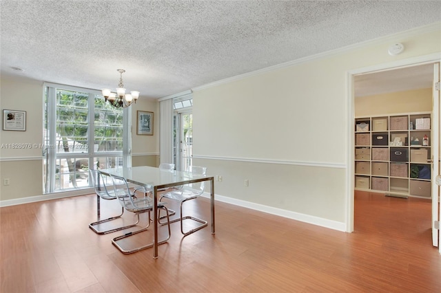 1280 S Alhambra Cir Unit 2206, Coral Gables, FL 33146 - dining area with a chandelier, a textured ceiling, plenty of natural light, wood finished floors, and crown molding