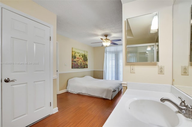 1280 S Alhambra Cir Unit 2206, Coral Gables, FL 33146 - bedroom featuring wood finished floors, a textured ceiling, and ceiling fan