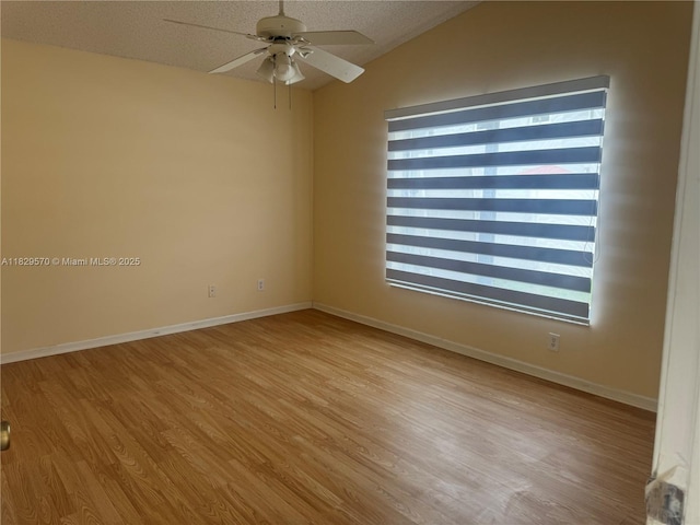 2383 SW 177th Ter, Miramar, FL 33029 - spare room with a ceiling fan, vaulted ceiling, light wood finished floors, and a textured ceiling