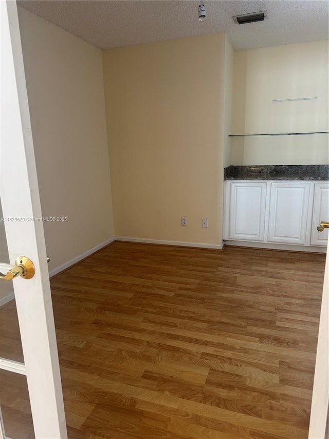 2383 SW 177th Ter, Miramar, FL 33029 - empty room featuring light wood-style flooring and a textured ceiling
