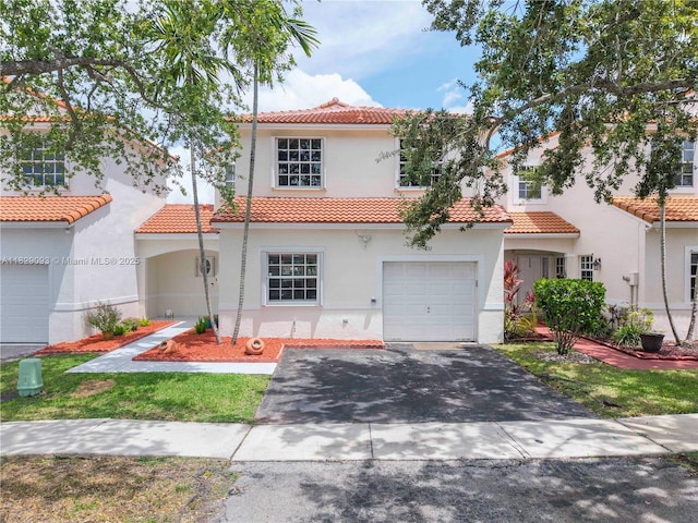 831 SW 178th Way, Pembroke Pines, FL 33029 - mediterranean / spanish-style house with a tiled roof, stucco siding, an attached garage, and asphalt driveway