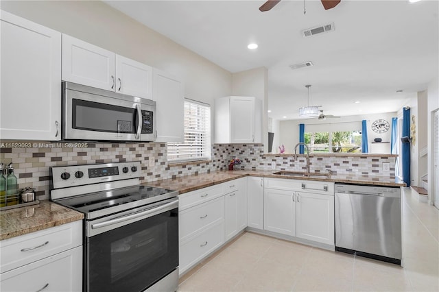831 SW 178th Way, Pembroke Pines, FL 33029 - kitchen featuring appliances with stainless steel finishes, a ceiling fan, healthy amount of natural light, white cabinets, and recessed lighting