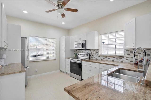 831 SW 178th Way, Pembroke Pines, FL 33029 - kitchen featuring stainless steel appliances, decorative backsplash, ceiling fan, white cabinets, and recessed lighting