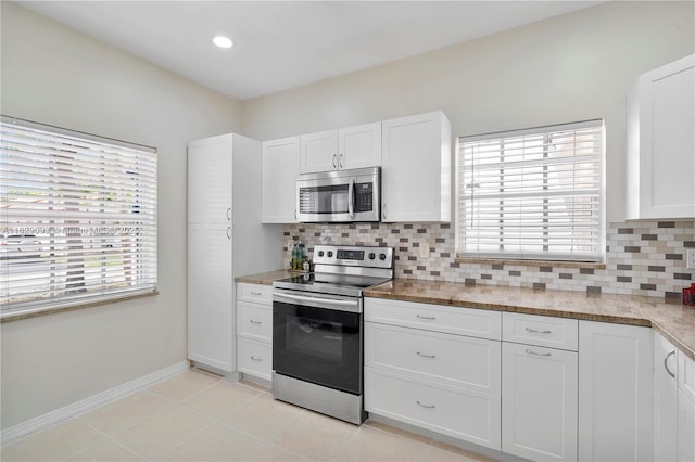 831 SW 178th Way, Pembroke Pines, FL 33029 - kitchen featuring stainless steel appliances, tasteful backsplash, white cabinets, light stone countertops, and light tile patterned floors