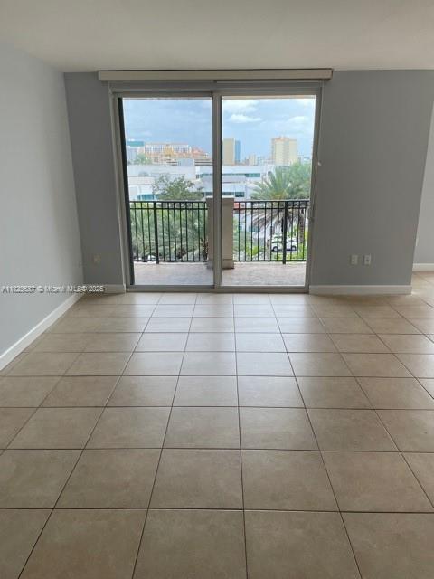2650 SW 37th Ave Unit 501, Miami, FL 33133 - tiled spare room featuring baseboards and a view of city