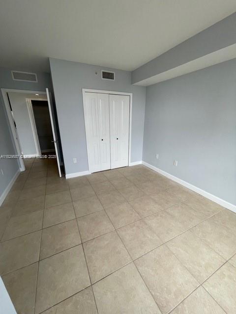 2650 SW 37th Ave Unit 501, Miami, FL 33133 - unfurnished bedroom with light tile patterned floors and a closet