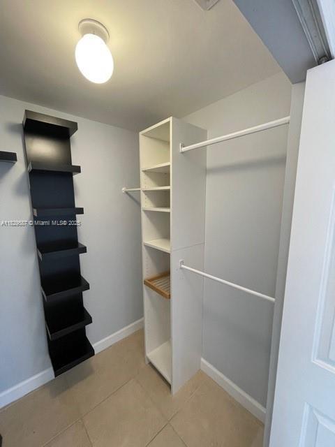 2650 SW 37th Ave Unit 501, Miami, FL 33133 - walk in closet featuring light tile patterned floors