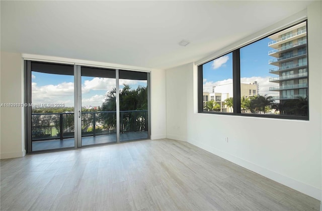 121 NE 34th St Unit 1009, Miami, FL 33137 - unfurnished room with wood finished floors and expansive windows