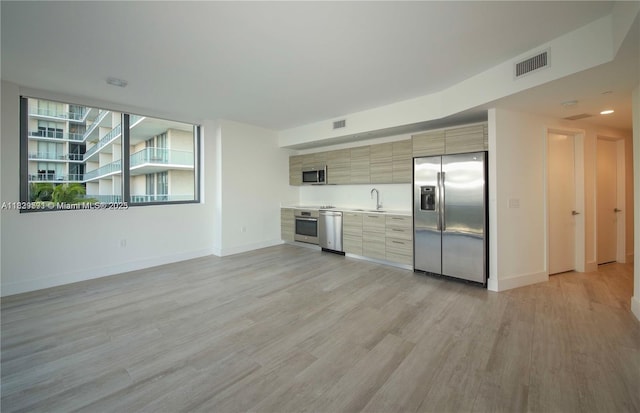 121 NE 34th St Unit 1009, Miami, FL 33137 - kitchen with stainless steel appliances, light wood-style flooring, modern cabinets, and light countertops