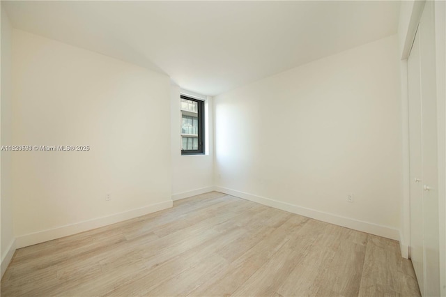 121 NE 34th St Unit 1009, Miami, FL 33137 - unfurnished room featuring light wood-style flooring and baseboards
