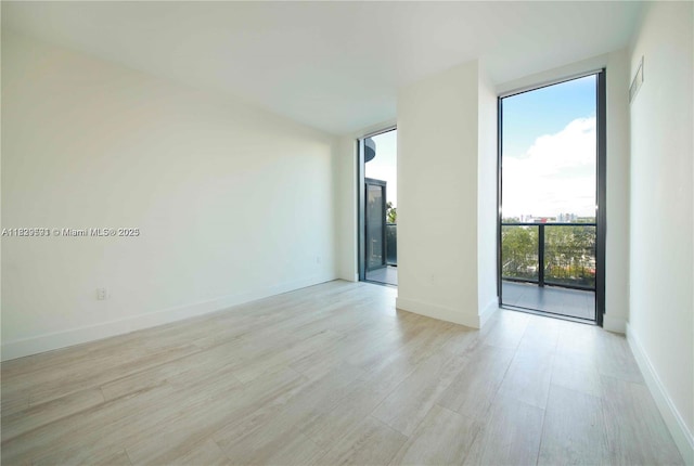 121 NE 34th St Unit 1009, Miami, FL 33137 - empty room featuring light wood-style floors and baseboards
