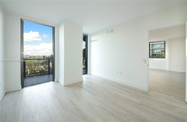 121 NE 34th St Unit 1009, Miami, FL 33137 - spare room with wood finished floors