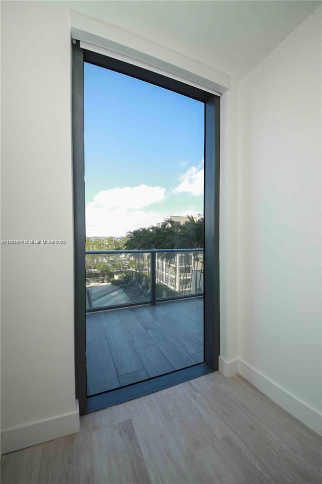121 NE 34th St Unit 1009, Miami, FL 33137 - unfurnished room featuring wood finished floors and floor to ceiling windows