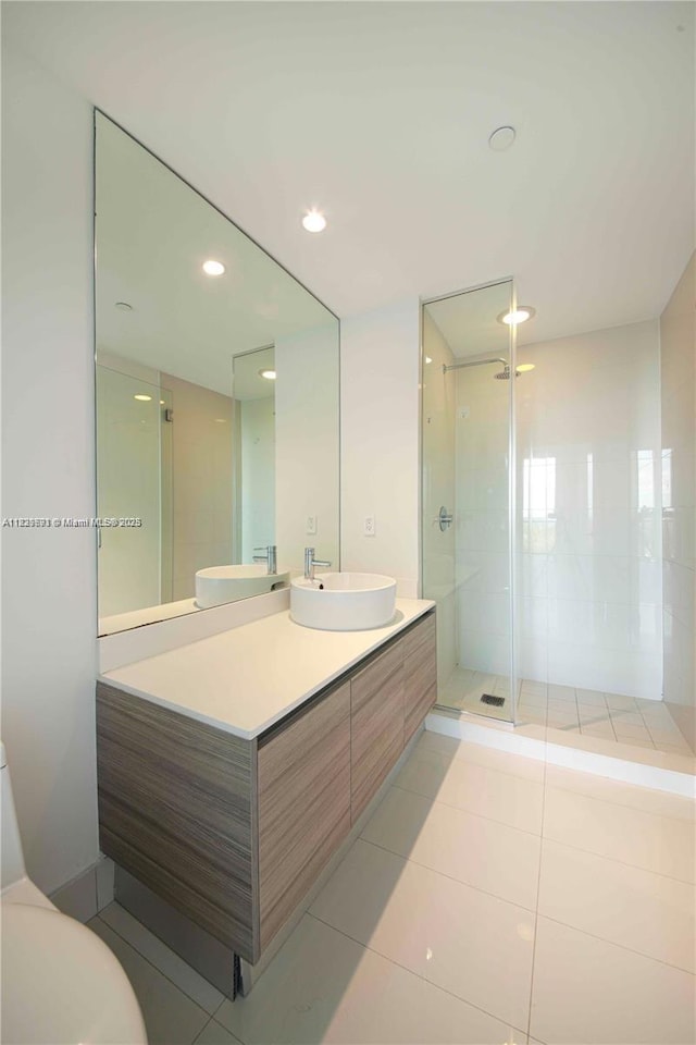 121 NE 34th St Unit 1009, Miami, FL 33137 - bathroom featuring vanity, a shower stall, tile patterned flooring, and recessed lighting