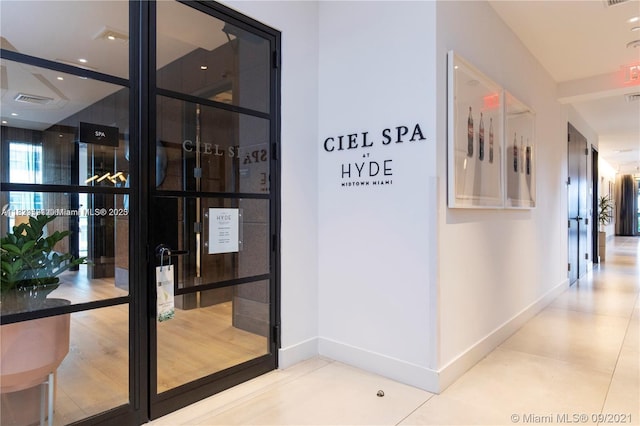 121 NE 34th St Unit 1009, Miami, FL 33137 - hall featuring baseboards and french doors