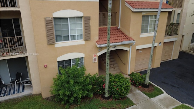 4021 San Marino Blvd Unit 102, West Palm Beach, FL 33409 - view of building exterior featuring a garage and driveway