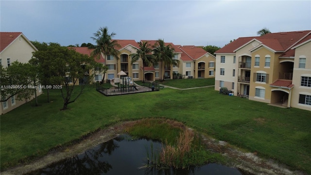 4021 San Marino Blvd Unit 102, West Palm Beach, FL 33409 - surrounding community featuring a yard, a water view, and a residential view