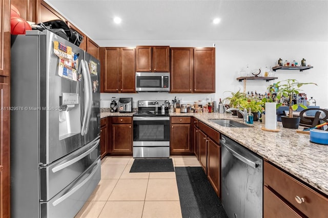 10962 SW 235, Homestead, FL 33032 - kitchen with stainless steel appliances, light tile patterned flooring, light stone countertops, open shelves, and recessed lighting