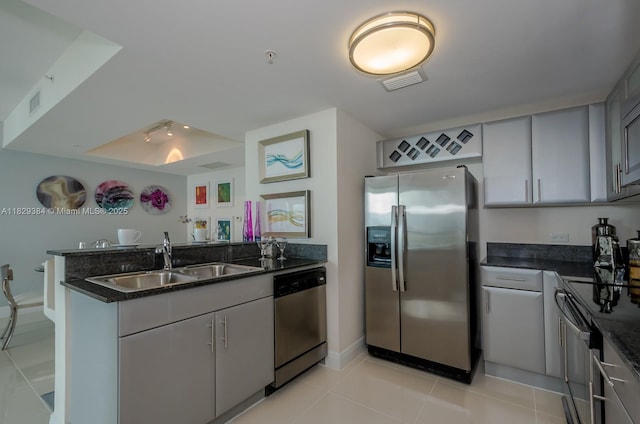 1871 NW S River Dr Unit 801, Miami, FL 33125 - kitchen featuring stainless steel appliances, a peninsula, light tile patterned floors, and gray cabinets