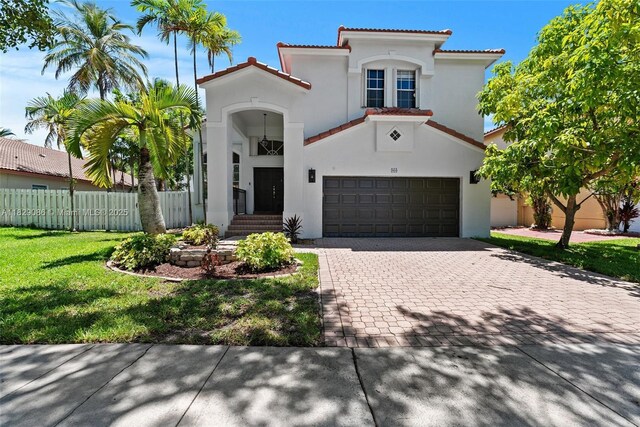 960 NW 185th Ave, Pembroke Pines, FL 33029 - mediterranean / spanish-style home featuring stucco siding, an attached garage, decorative driveway, and a tile roof