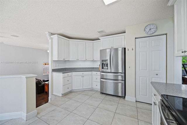 960 NW 185th Ave, Pembroke Pines, FL 33029 - kitchen with stainless steel appliances, white cabinetry, a textured ceiling, and light tile patterned floors