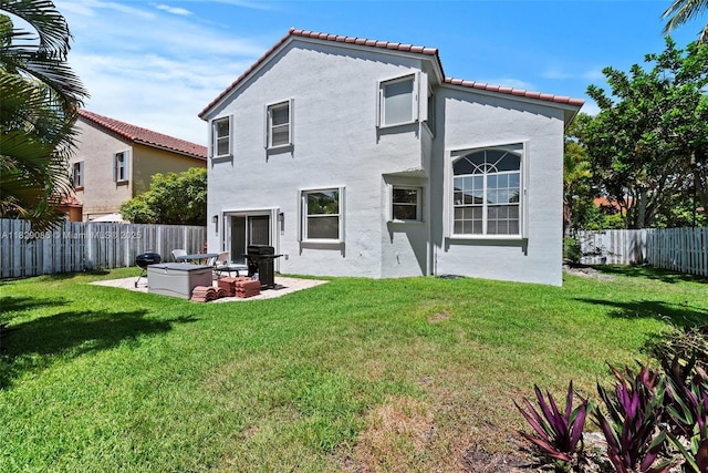 960 NW 185th Ave, Pembroke Pines, FL 33029 - rear view of house featuring a fenced backyard, stucco siding, a tiled roof, and a patio area