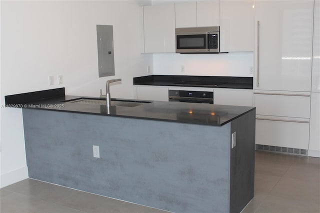 1010 Brickell Ave Unit 3403, Miami, FL 33131 - kitchen with stainless steel microwave, electric panel, wall oven, high end fridge, and white cabinets