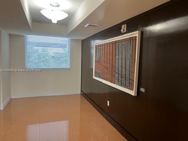 2775 NE 187th St Unit 202, Aventura, FL 33180 - empty room featuring baseboards and tile patterned flooring