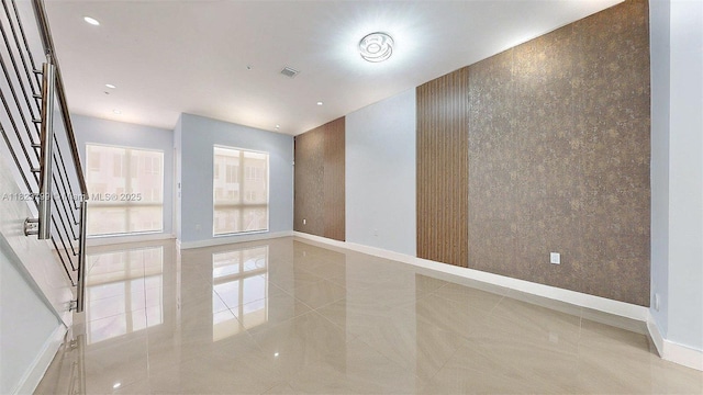 10255 NW 63rd Ter Unit 204, Doral, FL 33178 - spare room featuring stairway, an accent wall, and tile patterned floors