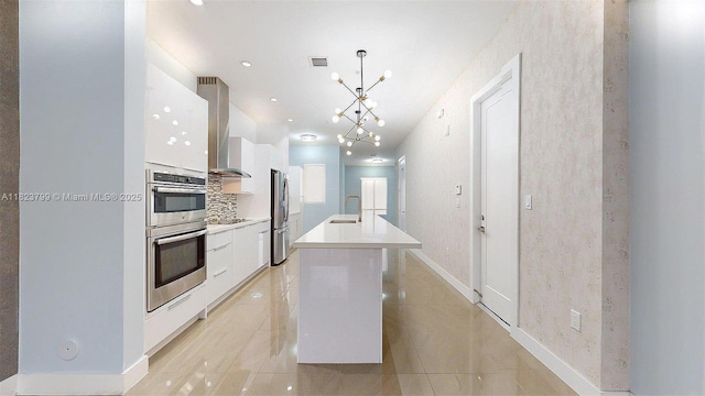 10255 NW 63rd Ter Unit 204, Doral, FL 33178 - kitchen with modern cabinets, stainless steel appliances, white cabinetry, wall chimney range hood, and a kitchen island with sink