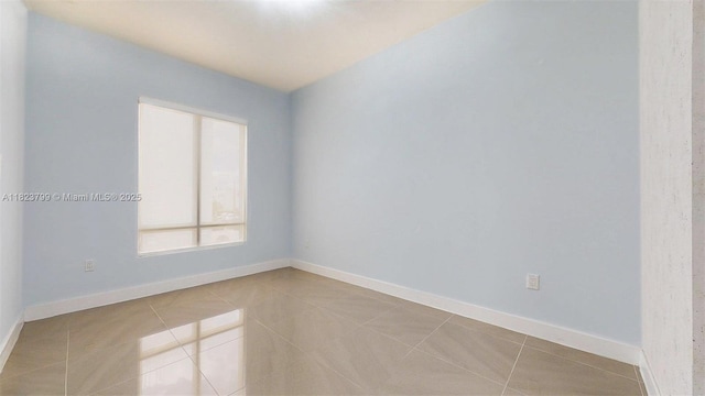 10255 NW 63rd Ter Unit 204, Doral, FL 33178 - tiled spare room with baseboards