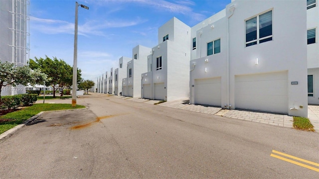 10255 NW 63rd Ter Unit 204, Doral, FL 33178 - view of asphalt street featuring a residential view and street lights