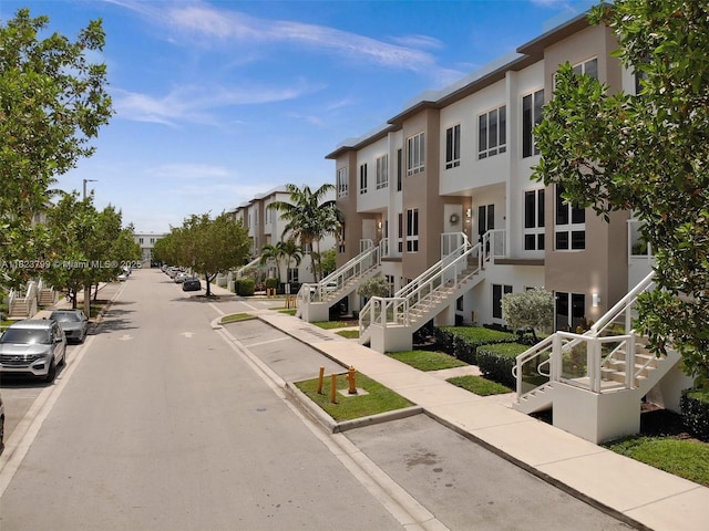 10255 NW 63rd Ter Unit 204, Doral, FL 33178 - view of asphalt road with sidewalks, stairs, a residential view, and curbs