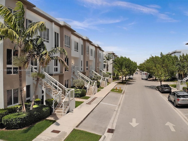 10255 NW 63rd Ter Unit 204, Doral, FL 33178 - view of asphalt street featuring sidewalks, a residential view, curbs, and stairs