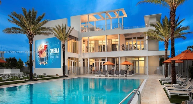 10255 NW 63rd Ter Unit 204, Doral, FL 33178 - back of house featuring a balcony, a community pool, a patio area, and stucco siding