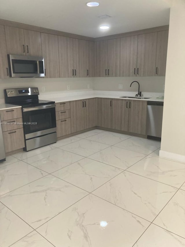 25767 SW 144th Ave, Homestead, FL 33032 - kitchen with stainless steel appliances, light marble finish floors, light countertops, and recessed lighting