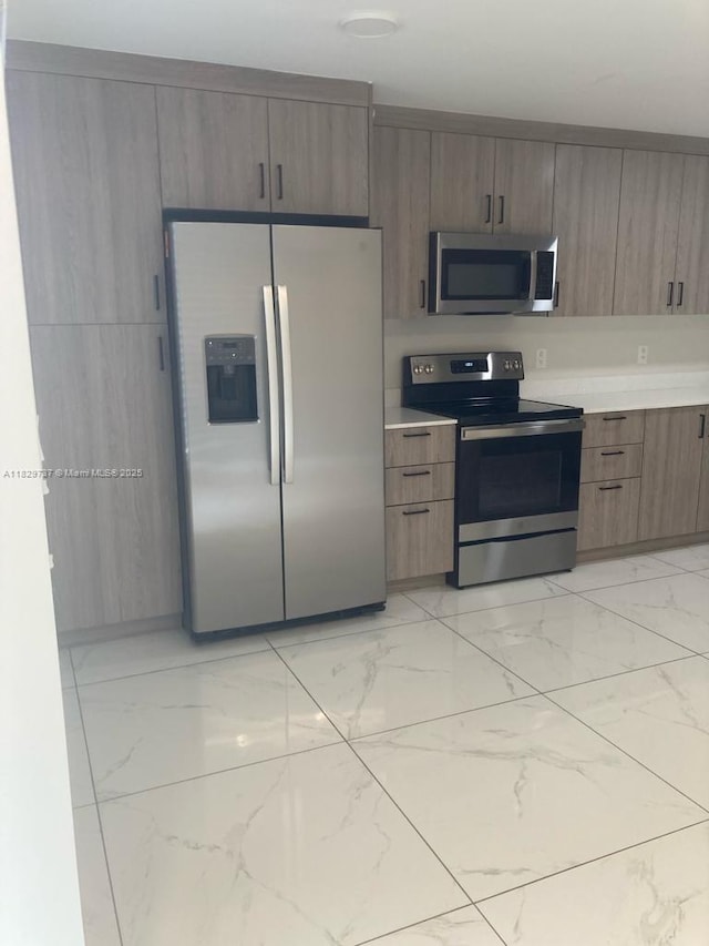 25767 SW 144th Ave, Homestead, FL 33032 - kitchen featuring appliances with stainless steel finishes and light marble finish floors