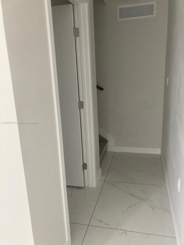 25767 SW 144th Ave, Homestead, FL 33032 - hallway featuring marble look tile flooring and baseboards
