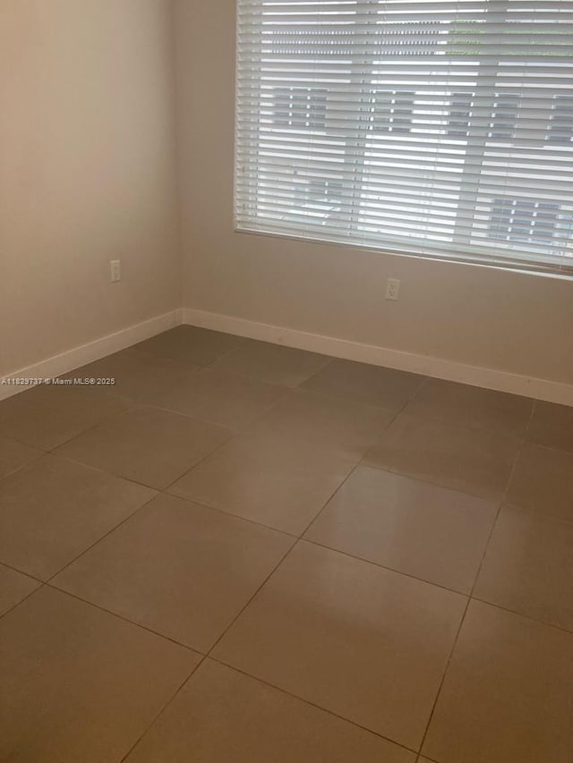 25767 SW 144th Ave, Homestead, FL 33032 - tiled spare room featuring baseboards