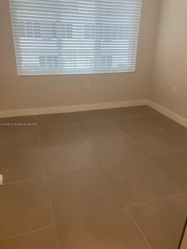 25767 SW 144th Ave, Homestead, FL 33032 - tiled empty room with baseboards