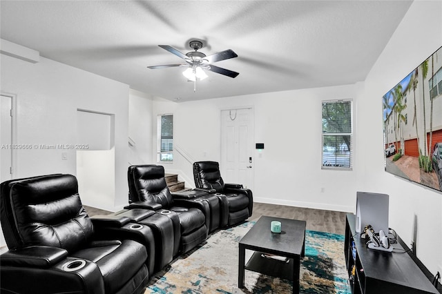 11898 SW 25th Ct Unit 103, Miramar, FL 33025 - home theater room featuring healthy amount of natural light, a ceiling fan, and wood finished floors