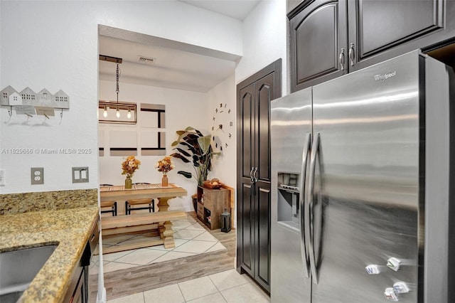 11898 SW 25th Ct Unit 103, Miramar, FL 33025 - kitchen with stainless steel refrigerator with ice dispenser, light stone counters, and light tile patterned floors