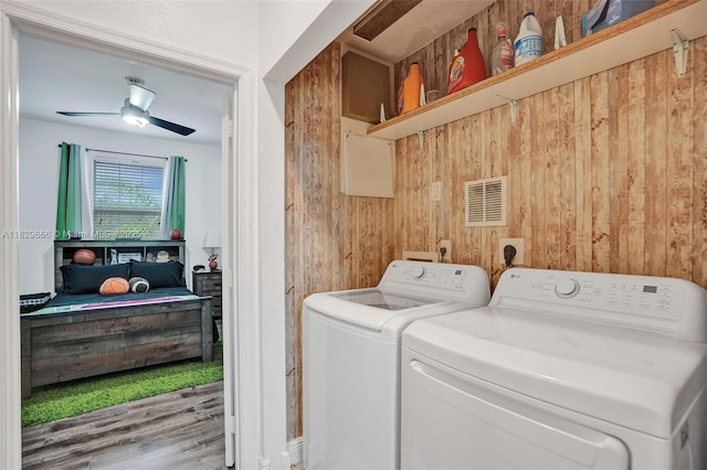 11898 SW 25th Ct Unit 103, Miramar, FL 33025 - washroom featuring separate washer and dryer, wood walls, and a ceiling fan