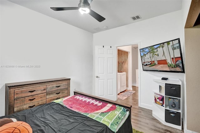 11898 SW 25th Ct Unit 103, Miramar, FL 33025 - bedroom with light wood-type flooring, washing machine and clothes dryer, and a ceiling fan