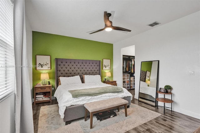 11898 SW 25th Ct Unit 103, Miramar, FL 33025 - bedroom featuring wood finished floors, a closet, an accent wall, and a ceiling fan