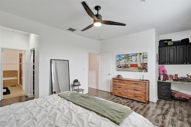 11898 SW 25th Ct Unit 103, Miramar, FL 33025 - bedroom featuring wood finished floors, an office area, a ceiling fan, and connected bathroom