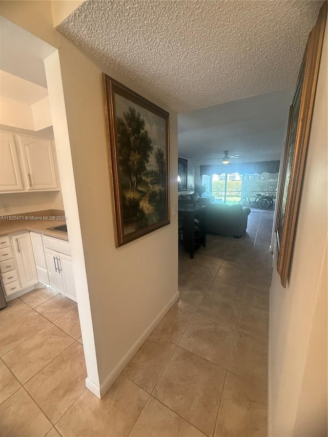 2371 SW 15th St Unit 101, Deerfield Beach, FL 33442 - hallway with light tile patterned floors and a textured ceiling