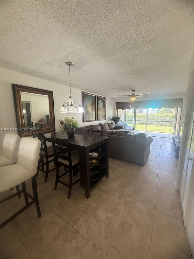 2371 SW 15th St Unit 101, Deerfield Beach, FL 33442 - dining room featuring light tile patterned floors, a textured ceiling, and a chandelier